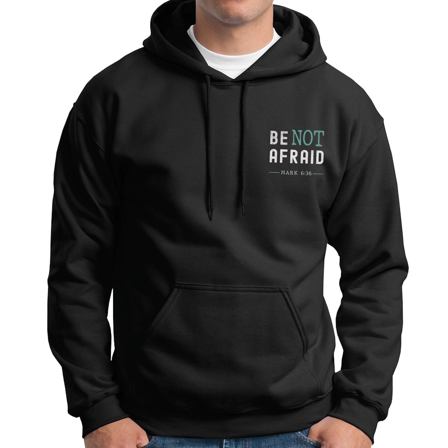 Man wearing a Do Not Be Afraid Only Believe Jesus Quote Mark 5:36 healing miracle bible verse Christian aesthetic textured black and teal printed on front and back of cozy black unisex hoodie sweatshirt for men and women