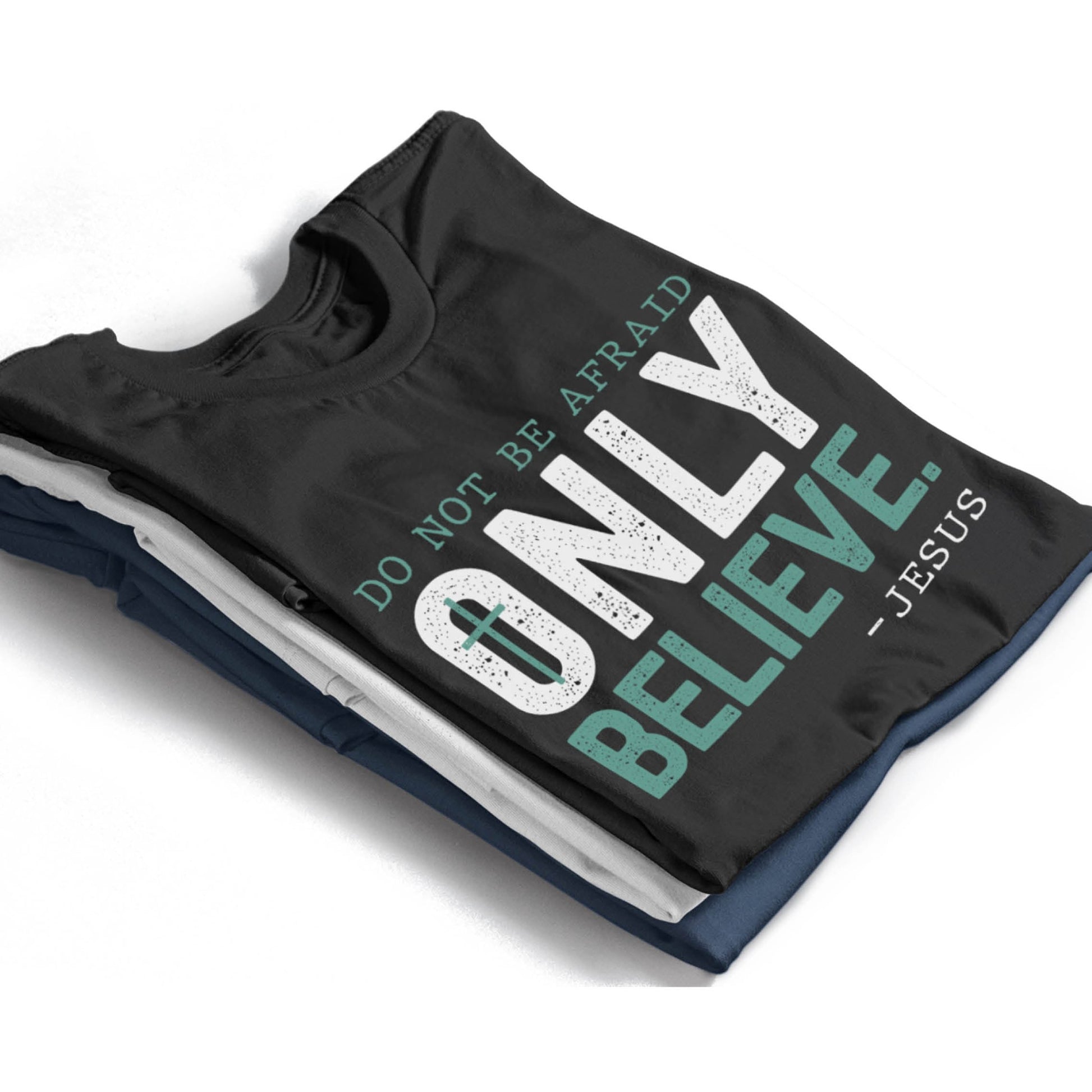 Stack of tees with Do Not Be Afraid, Only Believe, Jesus Quote Mark 5:36 healing miracle bible verse textured white and teal Christian aesthetic printed on soft black white navy blue unisex t-shirts for men and women