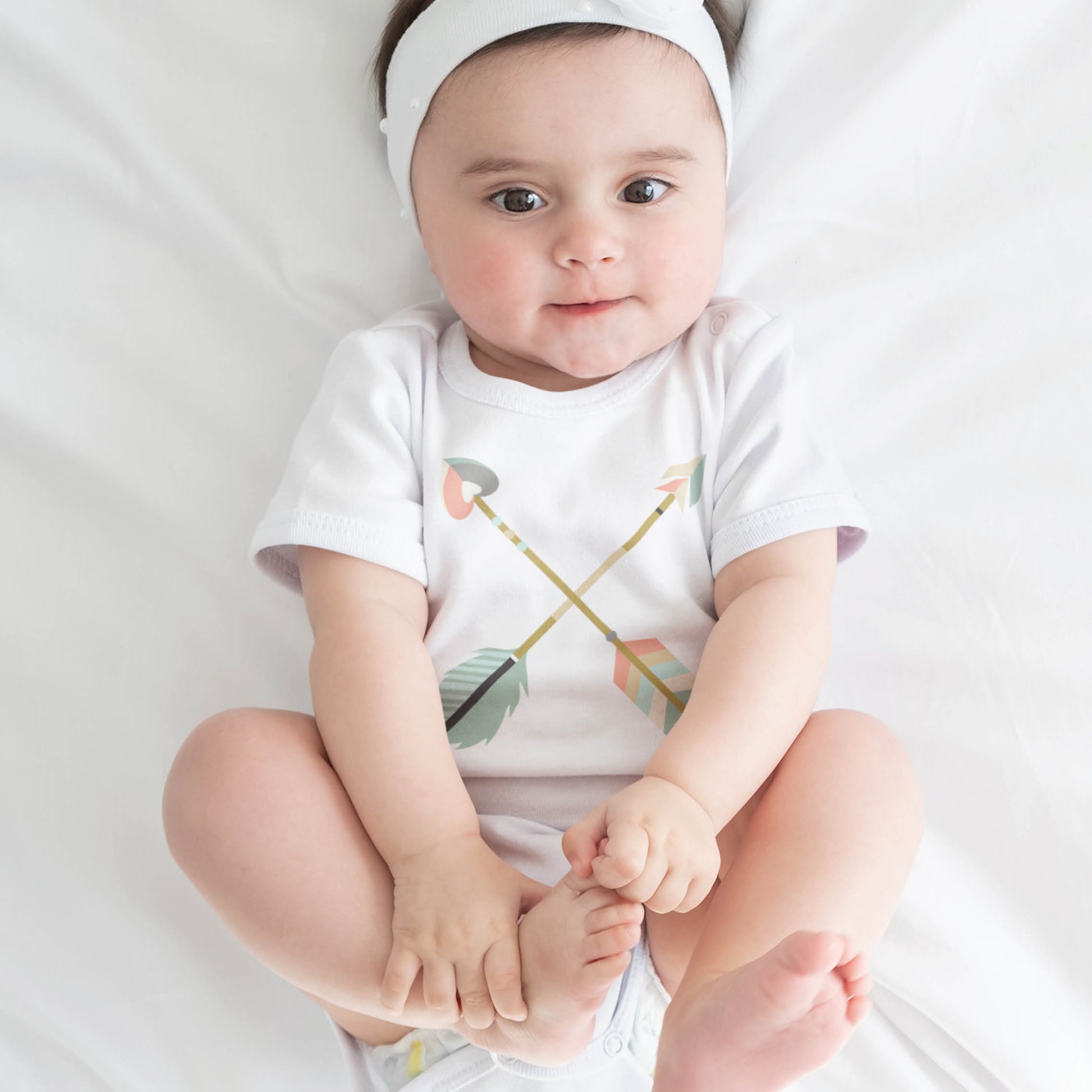 Cute 6 month old baby girl wearing a criss cross boho arrows white neutral baby onesie bodysuit for boys and girls, matching mommy-and-me Christian Raising Arrows Psalm 127:4-5 scripture faith-based Mom T-Shirt