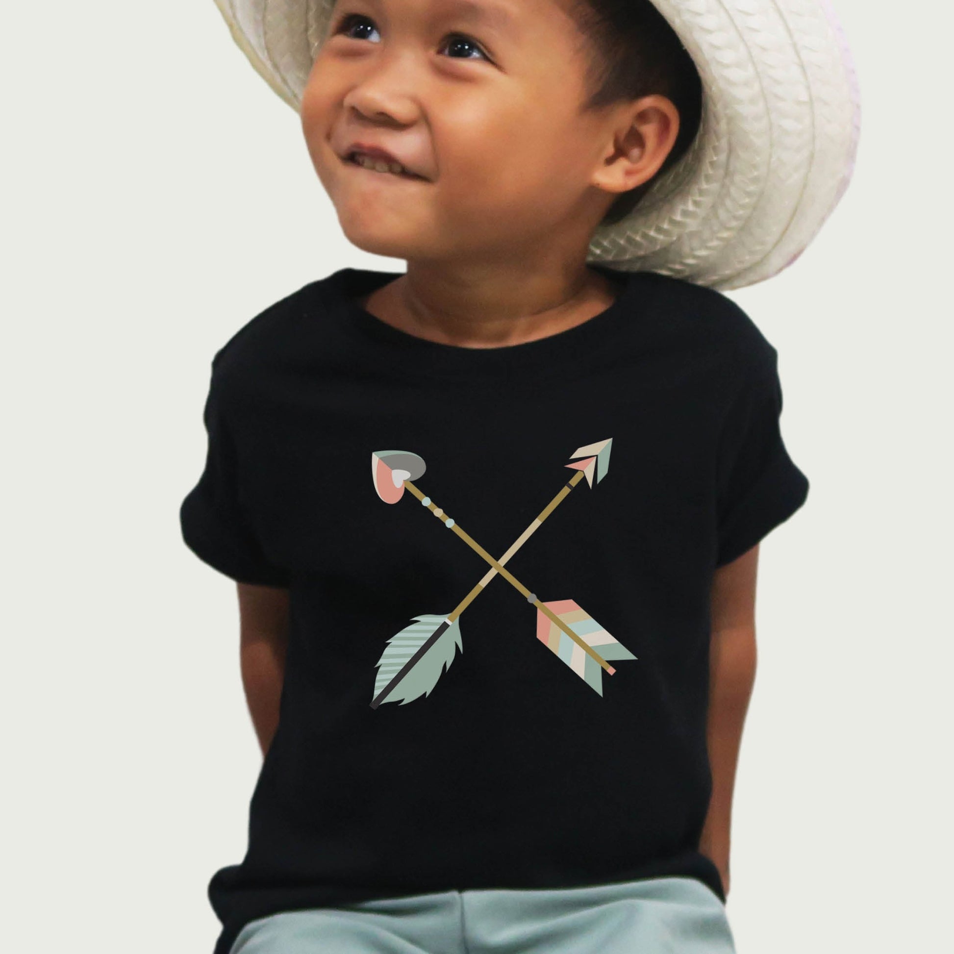Black toddler size t-shirt with pastel criss-cross boho arrows, one with a heart on the end, to match Christian mom's womens' "Raising Arrows" Psalm 127:4-5 bible verse t-shirt for boys and girls