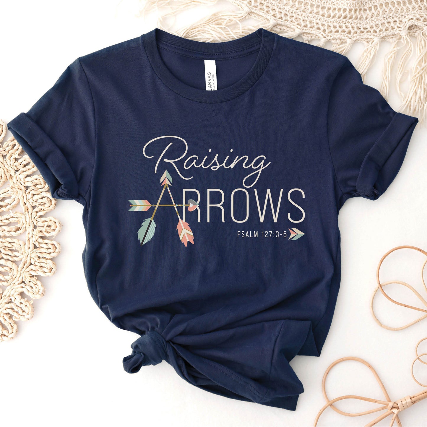 Navy blue and pastel boho arrow Christian aesthetic faith-based t-shirt with Psalm 127:3-5 bible verse quote that says "Raising Arrows" blessed is the one with a quiver full of children, perfect for homeschool moms and kids