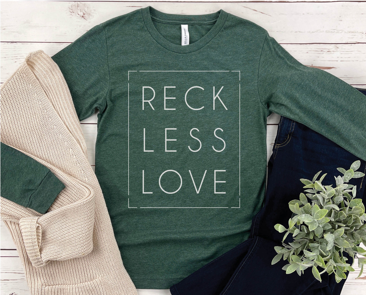 Rectangle Reckless Love Christian aesthetic worship design printed in white on cozy heather forest green unisex long sleeve tee shirt for men and women