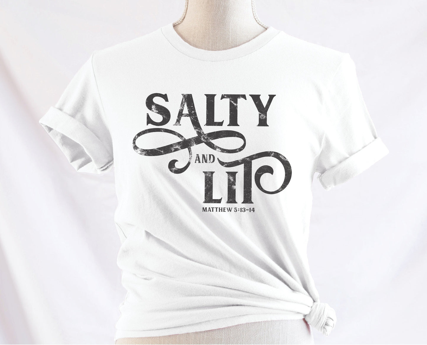 Salty And Lit Matthew 5:13-14 bible verse funny Christian T-Shirt design printed in charcoal gray on soft white tee for women