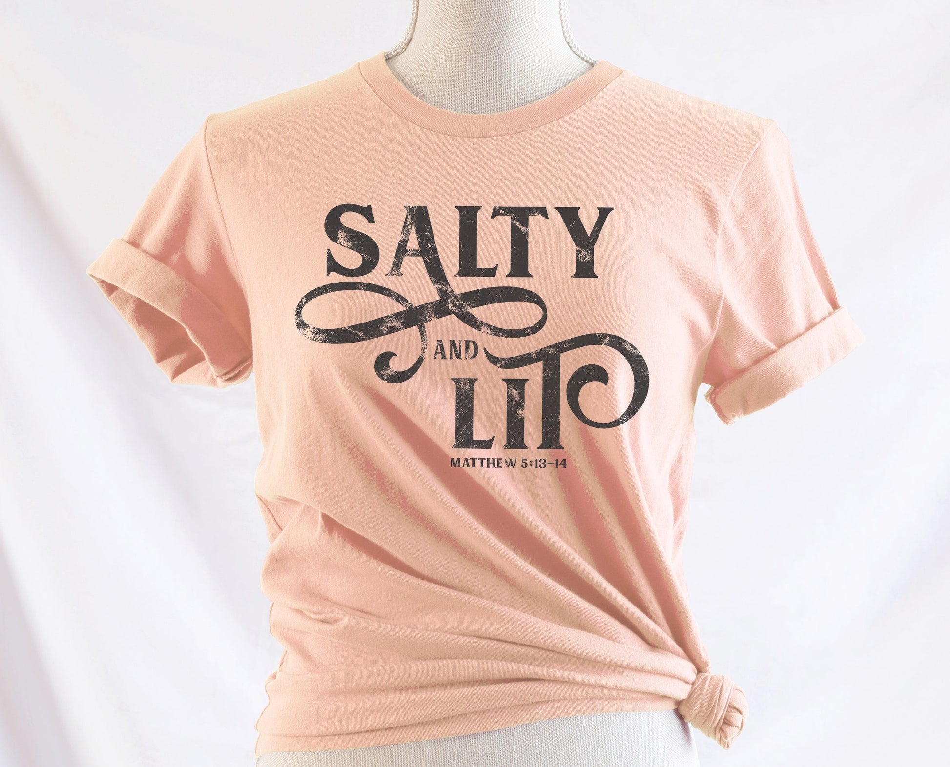 Salty And Lit Matthew 5:13-14 bible verse funny Christian T-Shirt design printed on soft heather prism peach tee for women
