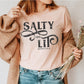 Salty And Lit Matthew 5:13-14 bible verse funny Christian T-Shirt design printed on soft heather prism peach tee for women