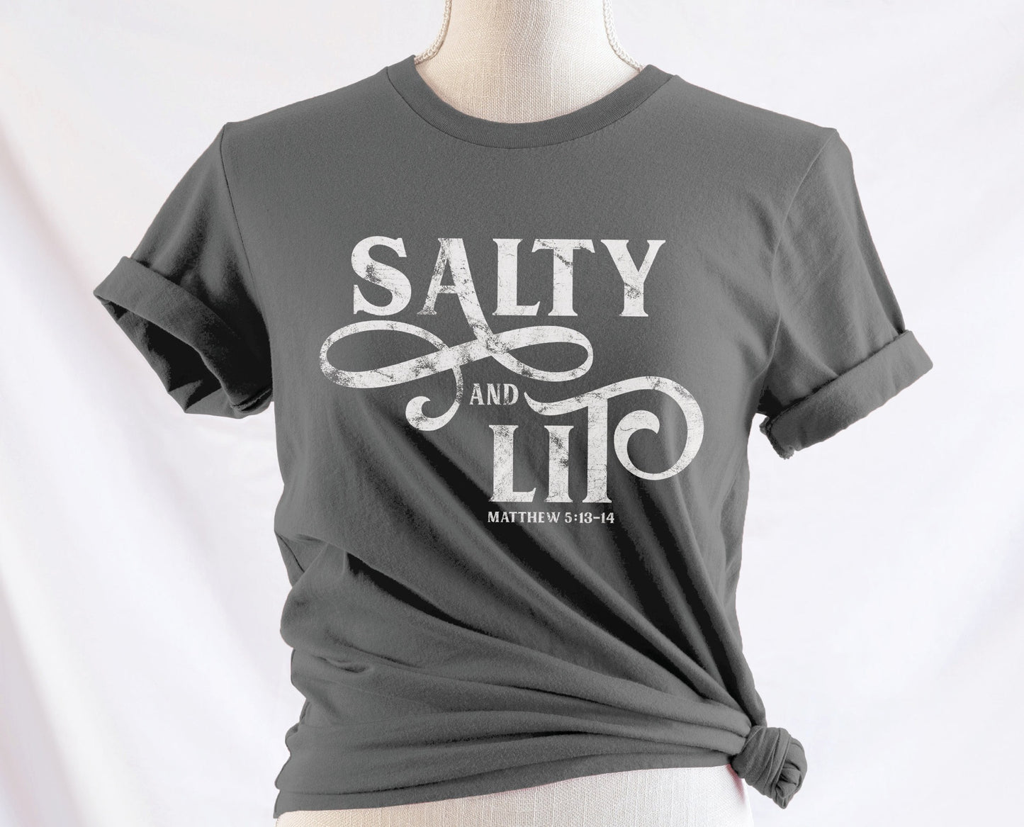 Salty And Lit Matthew 5:13-14 bible verse funny Christian T-Shirt design printed in white on soft asphalt gray tee for women