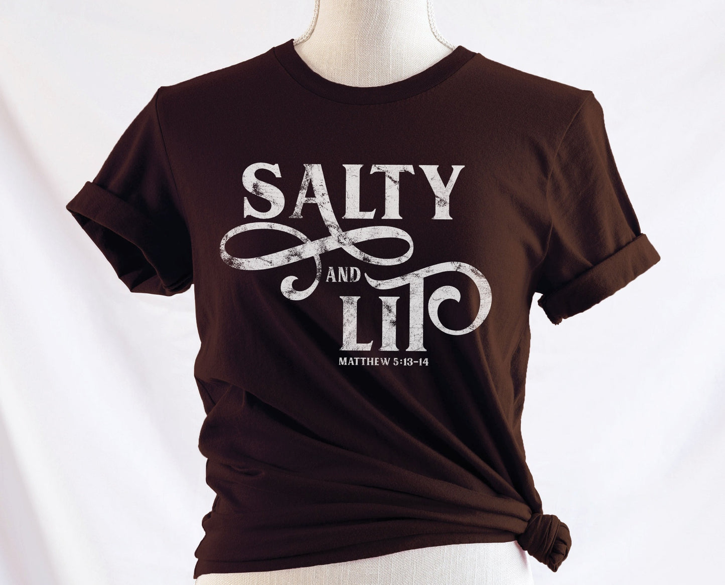 Salty And Lit Matthew 5:13-14 bible verse funny Christian T-Shirt design printed in white on soft mocha brown tee for women