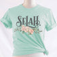 Selah Psalm bible verse watercolor floral Christian aesthetic design printed in charcoal gray, peach, blush pink, sage green, on soft heather prism mint t-shirt for women