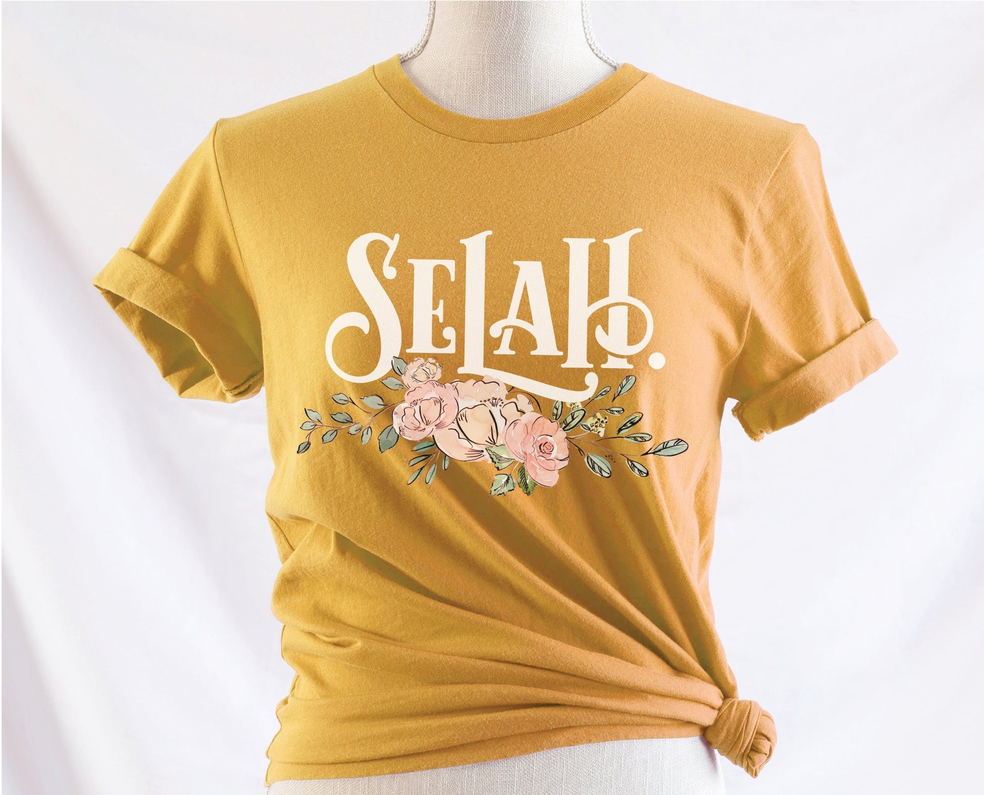 Selah Psalm bible verse watercolor floral Christian aesthetic design printed in white peach blush pink on soft mustard yellow t-shirt for women