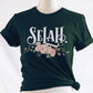 Selah Psalm bible verse watercolor floral Christian aesthetic design printed in white peach blush pink on soft forest green t-shirt for women