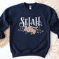 Selah Psalm watercolor floral Christian aesthetic design printed in white, peach, blush pink, and sage green on cozy navy blue unisex crewneck sweatshirt for women