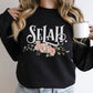 Selah Psalm watercolor floral Christian aesthetic design printed in white, peach, blush pink, and sage green on cozy black unisex crewneck sweatshirt for women