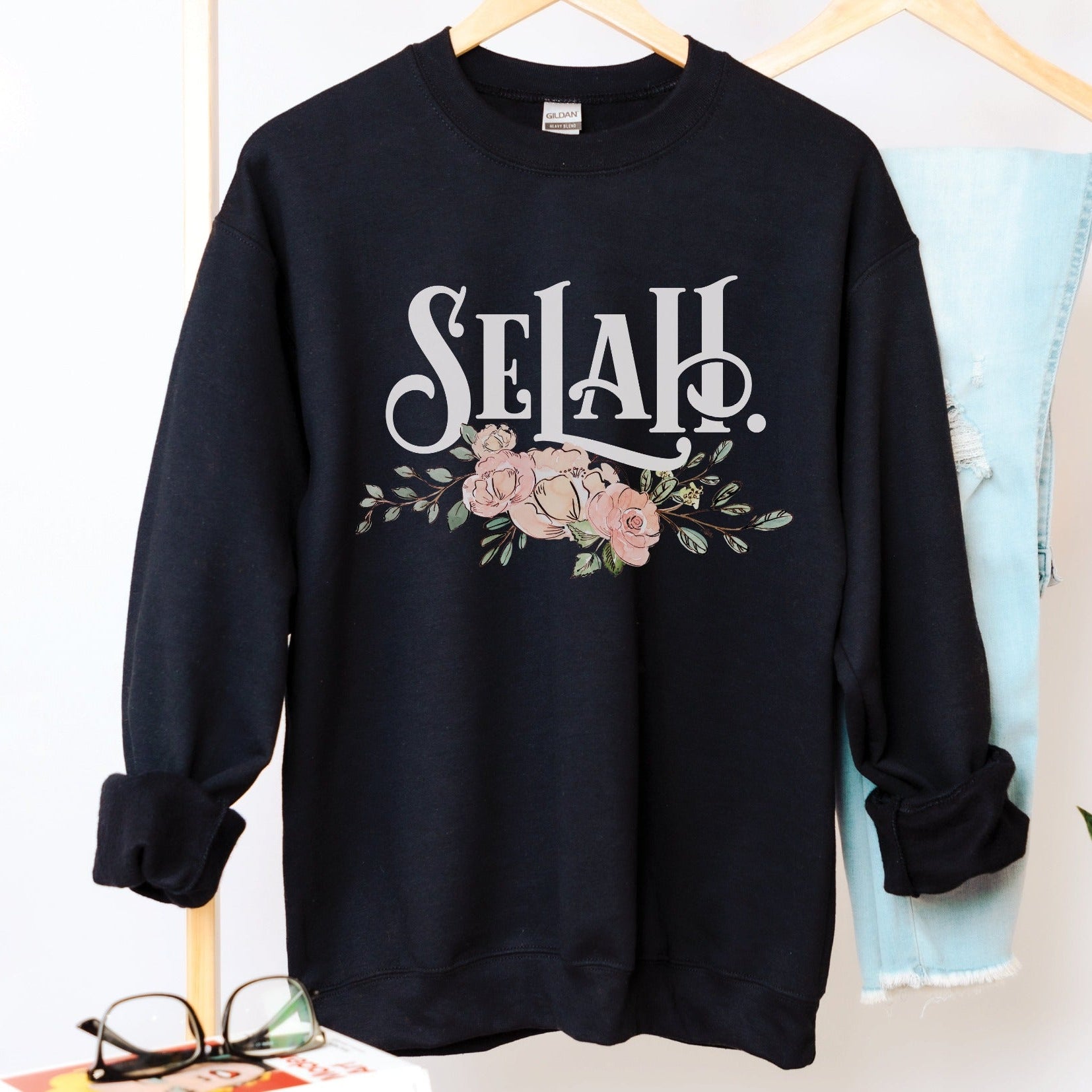 Selah Psalm watercolor floral Christian aesthetic design printed in white, peach, blush pink, and sage green on cozy black unisex crewneck sweatshirt for women