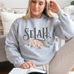 Selah Psalm watercolor floral Christian aesthetic design printed in charcoal gray, peach, blush pink, on cozy heather gray unisex crewneck sweatshirt for women
