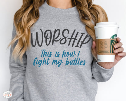 Worship This Is How I Fight My Battles Christian aesthetic unisex crewneck sweatshirt design printed in charcoal and teal on cozy heather gray sweater for women, great gift for worship leaders