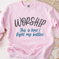 Worship This Is How I Fight My Battles Christian aesthetic unisex crewneck sweatshirt design printed in charcoal and teal on cozy light pink sweater for women, great gift for worship leaders