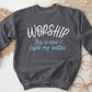 Worship This Is How I Fight My Battles Christian aesthetic unisex crewneck sweatshirt design printed in white and teal on cozy heather dark gray sweater for women, great gift for worship leaders