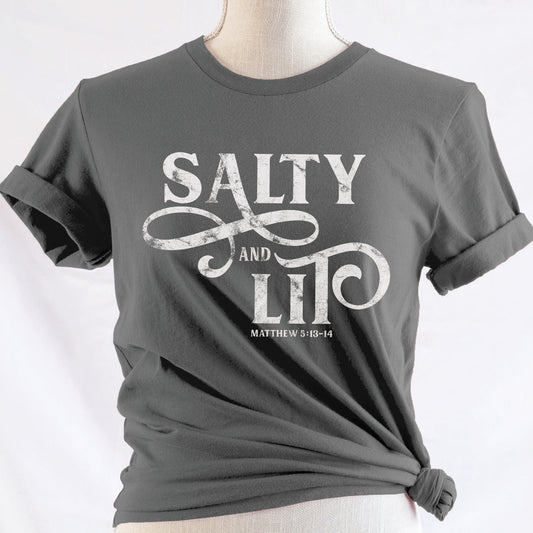 Salty And Lit Matthew 5:13-14 bible verse funny Christian T-Shirt design printed in white on soft asphalt gray tee for women